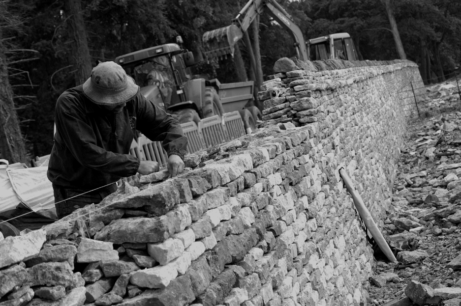 A man building a dry stone wall.